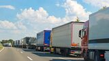 Autobahn,Trucks,background,blue,cloud,copy space,day,driving,germany,green,highway,in a row,nobody,outdoors,sky,summer,sunlight,traffic,traffic jam,transportation,vehicle,white