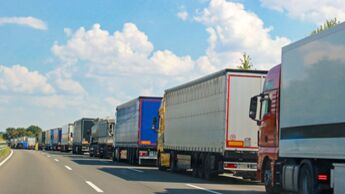 Autobahn,Trucks,background,blue,cloud,copy space,day,driving,germany,green,highway,in a row,nobody,outdoors,sky,summer,sunlight,traffic,traffic jam,transportation,vehicle,white