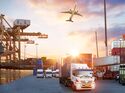 Container truck in ship port for business Logistics and transportation of Container Cargo ship and Cargo plane with working crane bridge in shipyard at sunrise, logistic import export and transport industry background