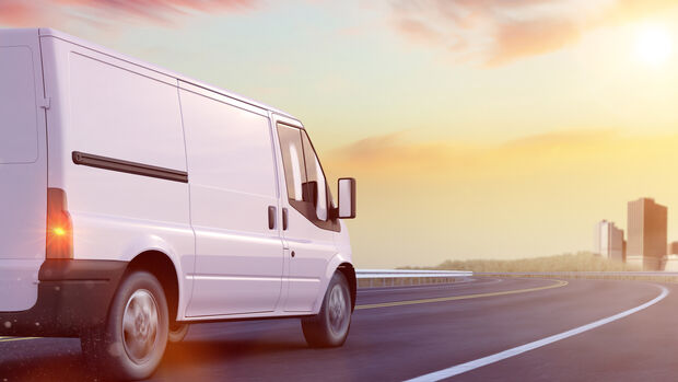 Delivery,Van,Driving,On,Road,To,Urban,City,(3d,Rendering)