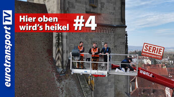 Drei Personen stehen in einer Hebebühne direkt neben dem historischen Kirchturm von Nördlingen in großer Höhe. Zu sehen sind das eurotransportTV-Logo, der Serienstempel sowie der Thumbnail-Text „Hier oben wird’s heikel #4“.