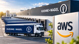 Kühne+Nagel-Logistikzentrum mit Lkw und AWS-Logo. Kühne+Nagel vereinbart eine langfristige strategische Zusammenarbeit mit Amazon.
