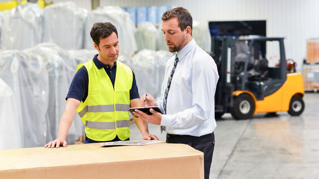 Manager of a logistics company are working instruction of skilled workers, Saxony-Anhalt, Germany