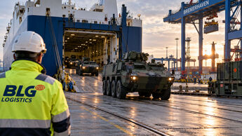 Symbolbild zur Militärlogistik in Bremerhaven mit Militärfahrzeugen beim Umschlag eines RoRo-Schiffs im Hafen.