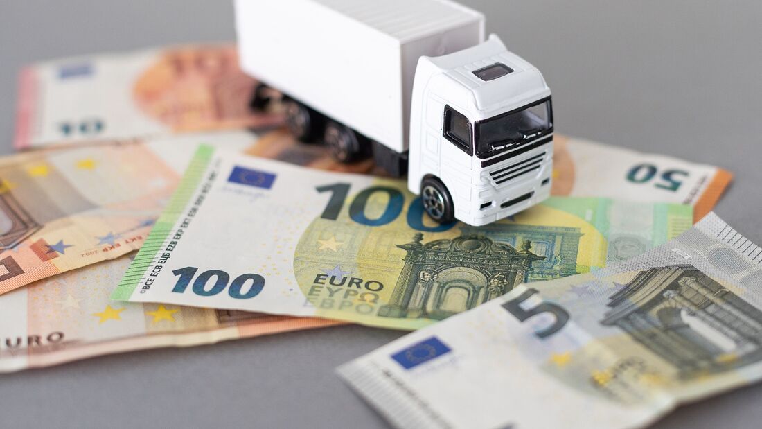 Toy car truck with money isolated on white background. High quality photo