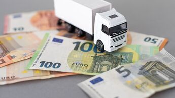 Toy car truck with money isolated on white background. High quality photo