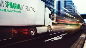 White,Truck,Moving,Fast,On,The,Road,In,A,Modern